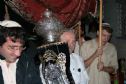 Gideon's father carries the Torah to the Synagogue