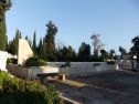 The mass grave with the airplane tail shaped tombstone